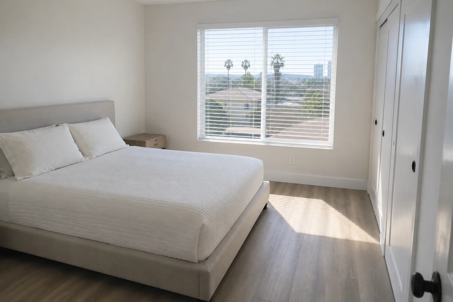 Bedroom cleaned with the bed made and surfaces dusted