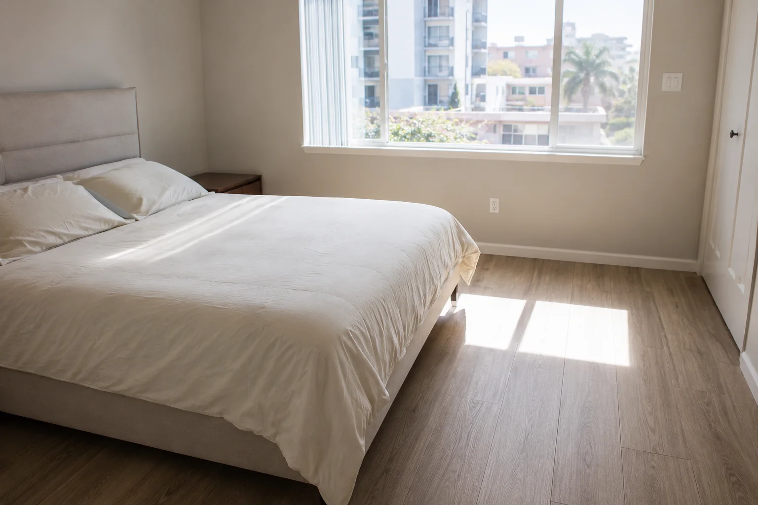 Sunlit bedroom cleaned and made up